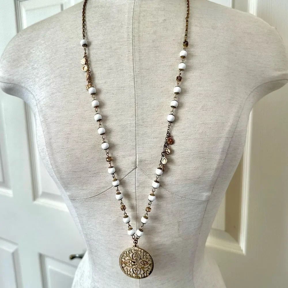 Long gold tone white beaded pendant necklace
